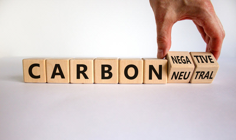 Hand flips cubes and changes words 'carbon neutral' to 'carbon negative'