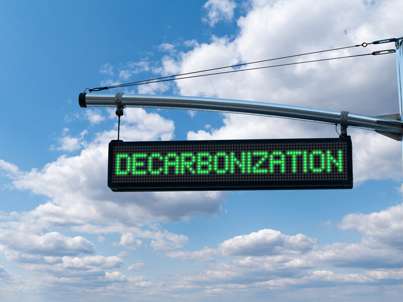 Road information board with text DECARBONIZATION