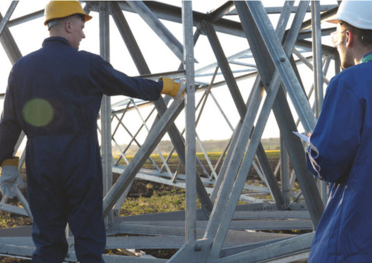 Two men wearing safety helmet and clothes in a construction site