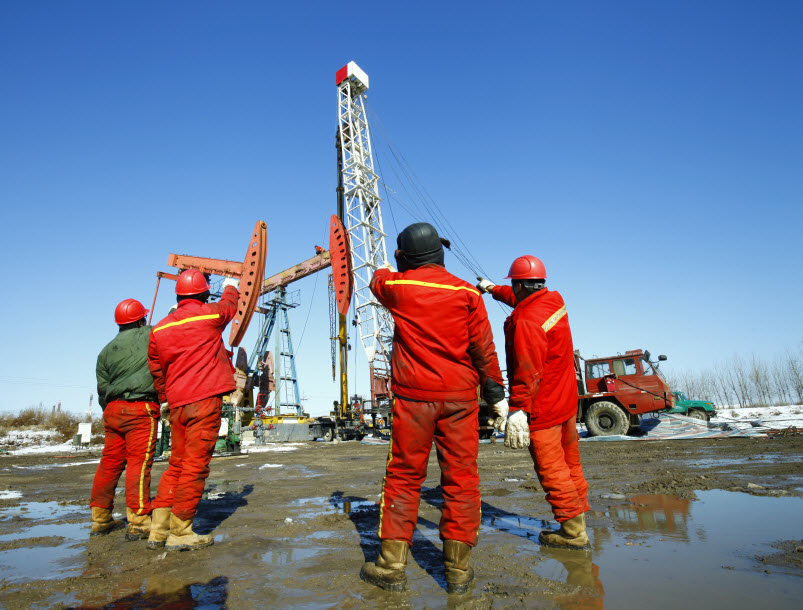 Uniformed oil workers on site